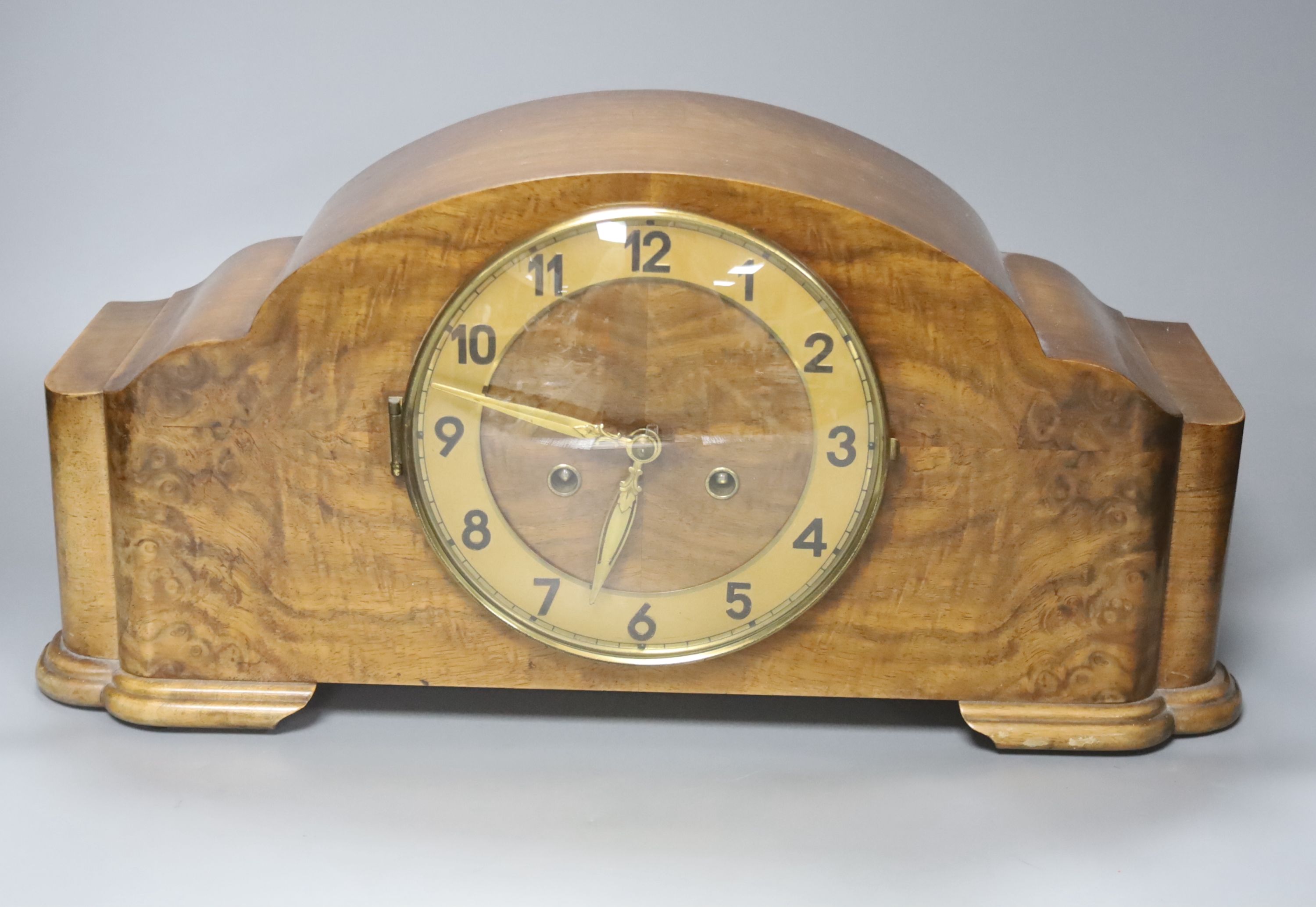 A 1920's walnut cased mantle clock, 42cm wide, 14cm deep, 22cm high and a brass bulkhead wall clock, 22cm diameter.